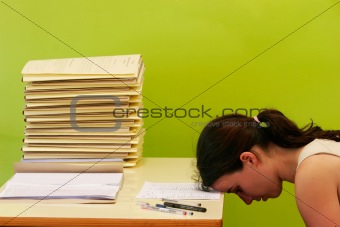 woman has stress because of huge work on her desk