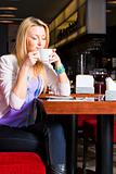 Young Woman Drinking Coffee in Cafe