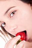 a beautiful woman eating strawberries