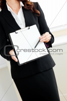 Close-up of an assertive businesswoman showing a contract