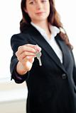Portrait of an assertive businesswoman holding a key