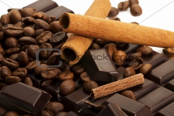 coffee beans on a chocolate bar with cinnamon sticks