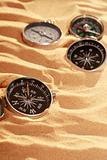 Compasses On Sand