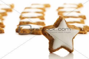 star shaped cinnamon biscuit in front of many