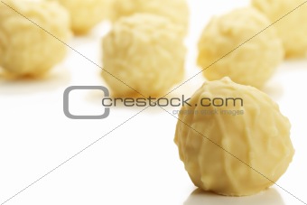 yellow truffle praline in front of many