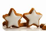 two standing star shaped cinnamon biscuits