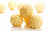 some yellow truffle pralines in front of others