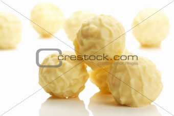 some yellow truffle pralines in front of others