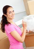 Smiling caucasian woman unpacking boxes with glasses