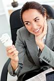 Young businesswoman holding a light bulb