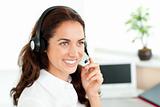 Smiling woman with headset working in a call center