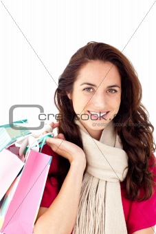 Hispanic woman wearing a scarf and holding shopping bags
