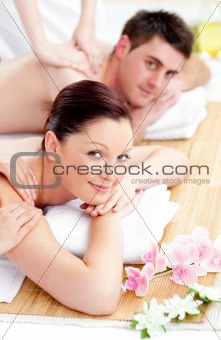 Merry young couple enjoying a back massage