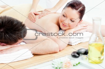 Delighted young couple receiving a back massage
