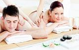 Delighted young couple receiving a back massage