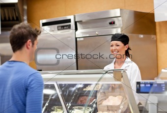 Portrait of a smiling food retailer with a male customer
