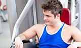 Relaxed young man using a bench press