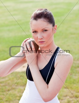 Determined female athlete ready to throw weight