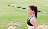Concentrated female athlete ready to throw javelin