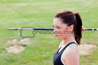 Concentrated athletic woman ready to throw the javelin