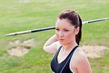 Determined female athlete ready to throw javelin