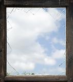 Broken window with old wooden frame