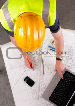 Builder inspects construction plans.