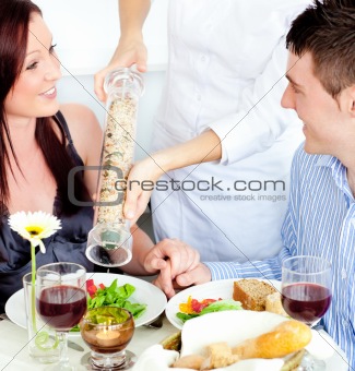 Merry young couple dining at the restaurant