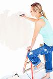Animated young woman painting a room
