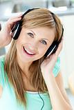 Delighted caucasian woman listening to music with headphones in 