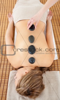 Pretty woman receiving hot stones on her back