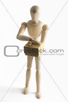 Wooden mannequin with a gift in hands
