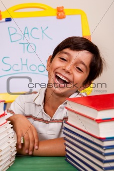 Smiling boy with school books