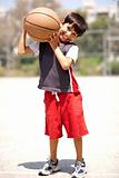 Boy with basketball on his shoulders