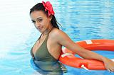 Young woman in a swimming pool with a lifebuoy