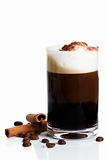 espresso with milk froth cocoa powder and cinnamon sticks on white