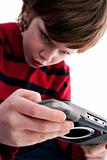 Young boy playing handheld game console