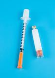  Insulin and syringe on a blue background