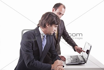 Two businessmen working together on a laptop