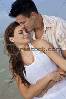 Man and Woman Couple In Romantic Embrace On A Beach