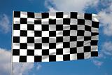 Waving checkered flag in front of a cloudy sky