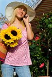 Beautiful Girl On Cell Phone With Sun Hat and Sunflowers