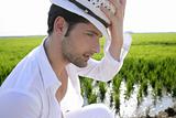 Mediterranean man portrait white hat inmeadow