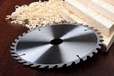 Circ saw blades, planks and shavings on dark background