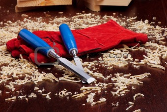 Chisels, red gloves and wood shavings