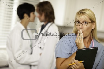 Alarmed Medical Woman Witnesses Her Colleagues Inner Office Romance Display.