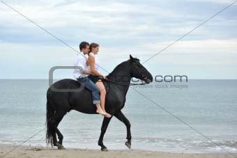 couple and  horse on the beach
