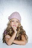 Thinking gesture little girl winter pink cap portrait