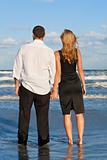 Man and Woman Couple Holding Hands On A Beach