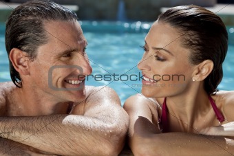Beautiful Couple Relaxing In Swimming Pool With Perfect Smiles